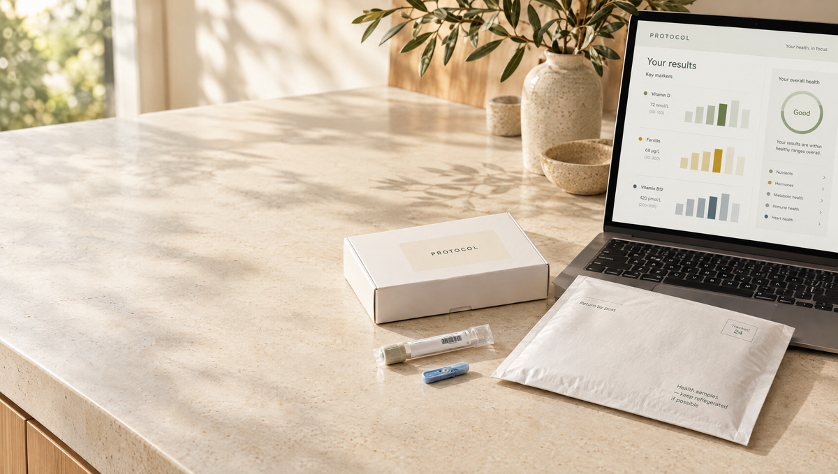 At-home blood test kit beside a laptop showing results